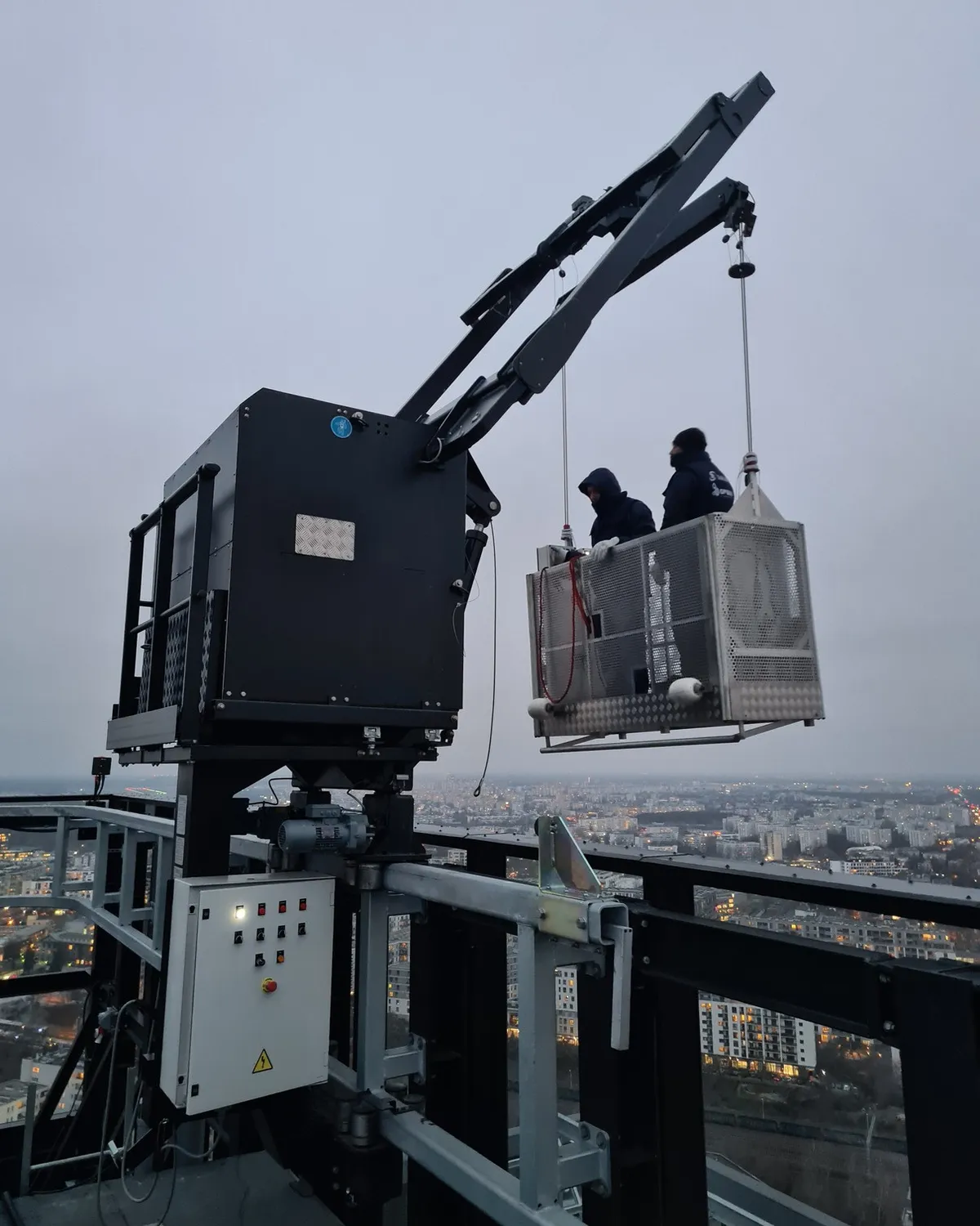 GPBMU GPN BMU lowering operators in a cradle from the roof of Forest Tower, Warsaw