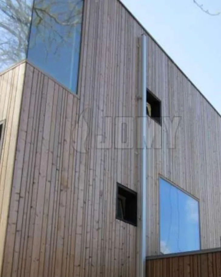 Jomy retractable ladder concealed in a timber-clad facade