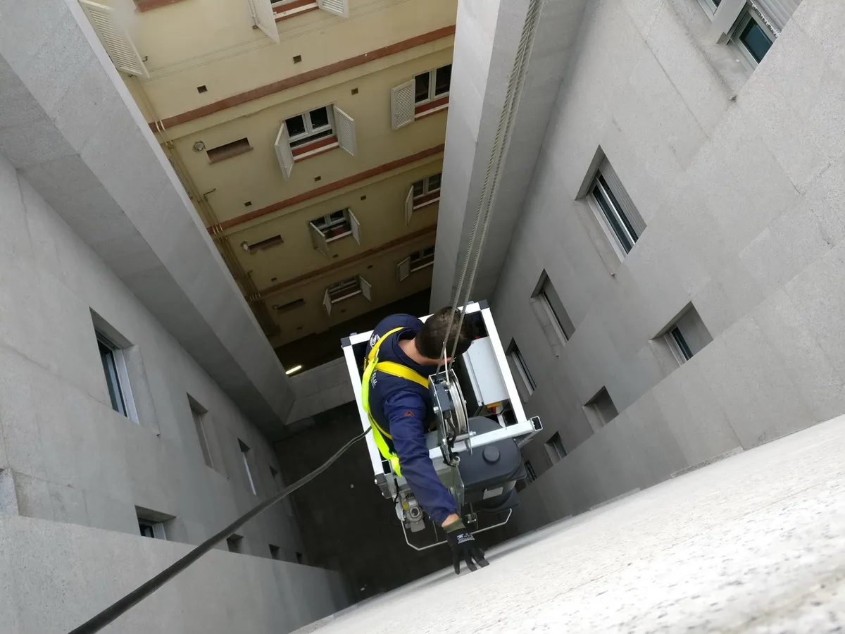 GPBMU technician working in a building service shaft